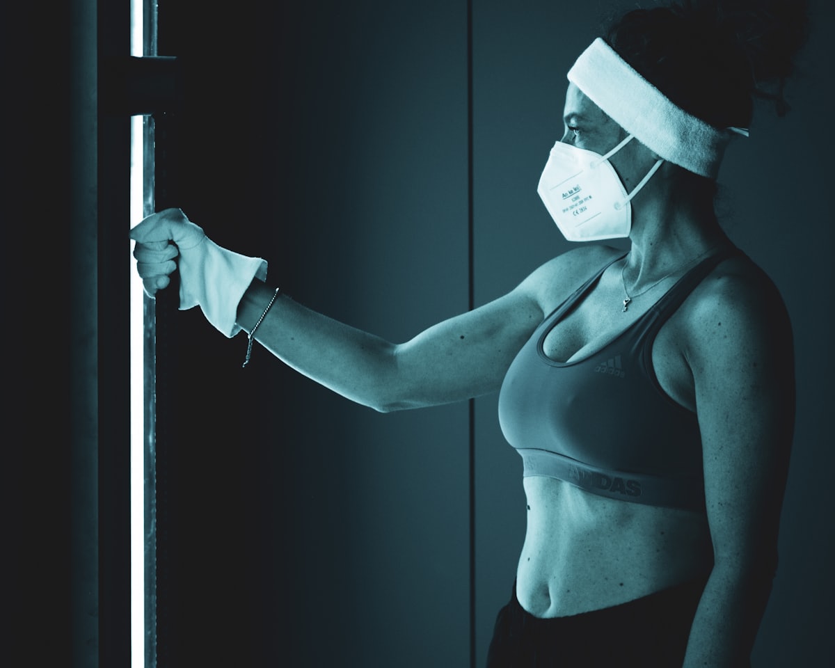 Athlete stepping into a whole-body cryotherapy chamber