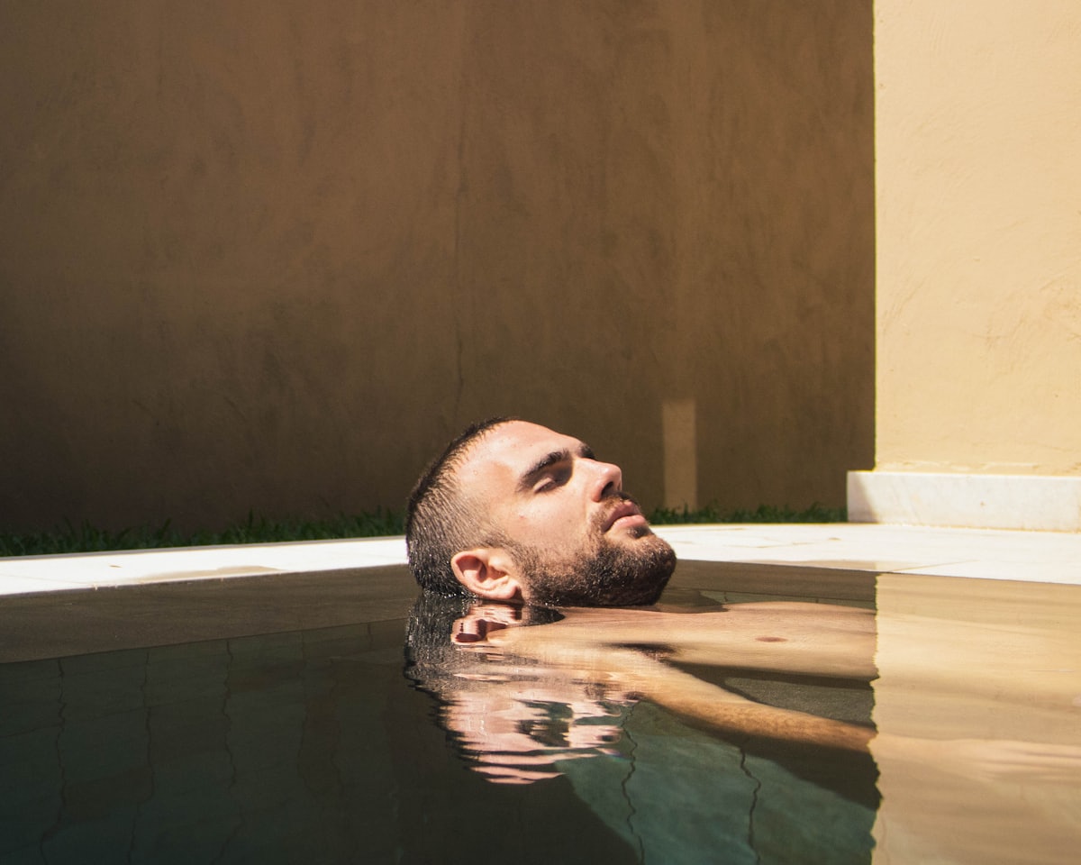 Person floating weightless in warm, still water